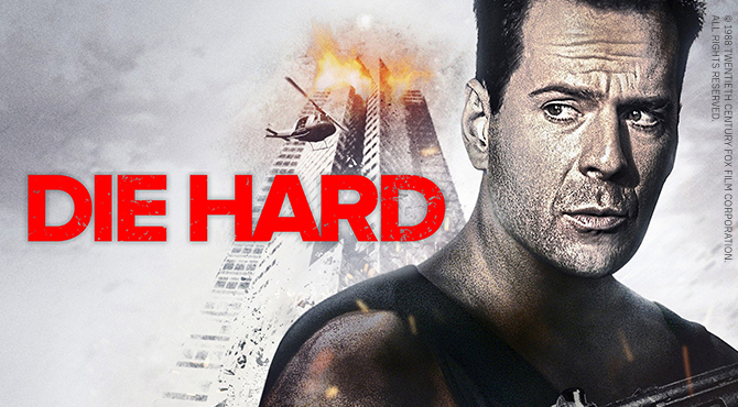 Мужчина смотрит в сторону, позади него — горящее здание и вертолет.