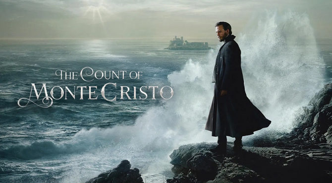 a man dressed black looking down the sea